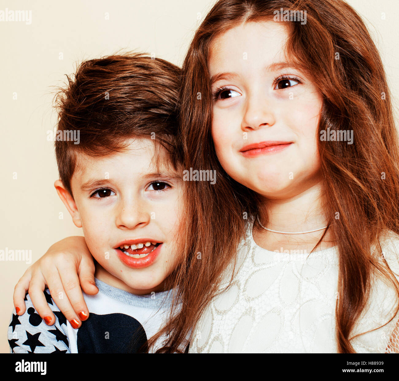 little cute boy and girl hugging playing on white background, ha Stock Photo Alamy