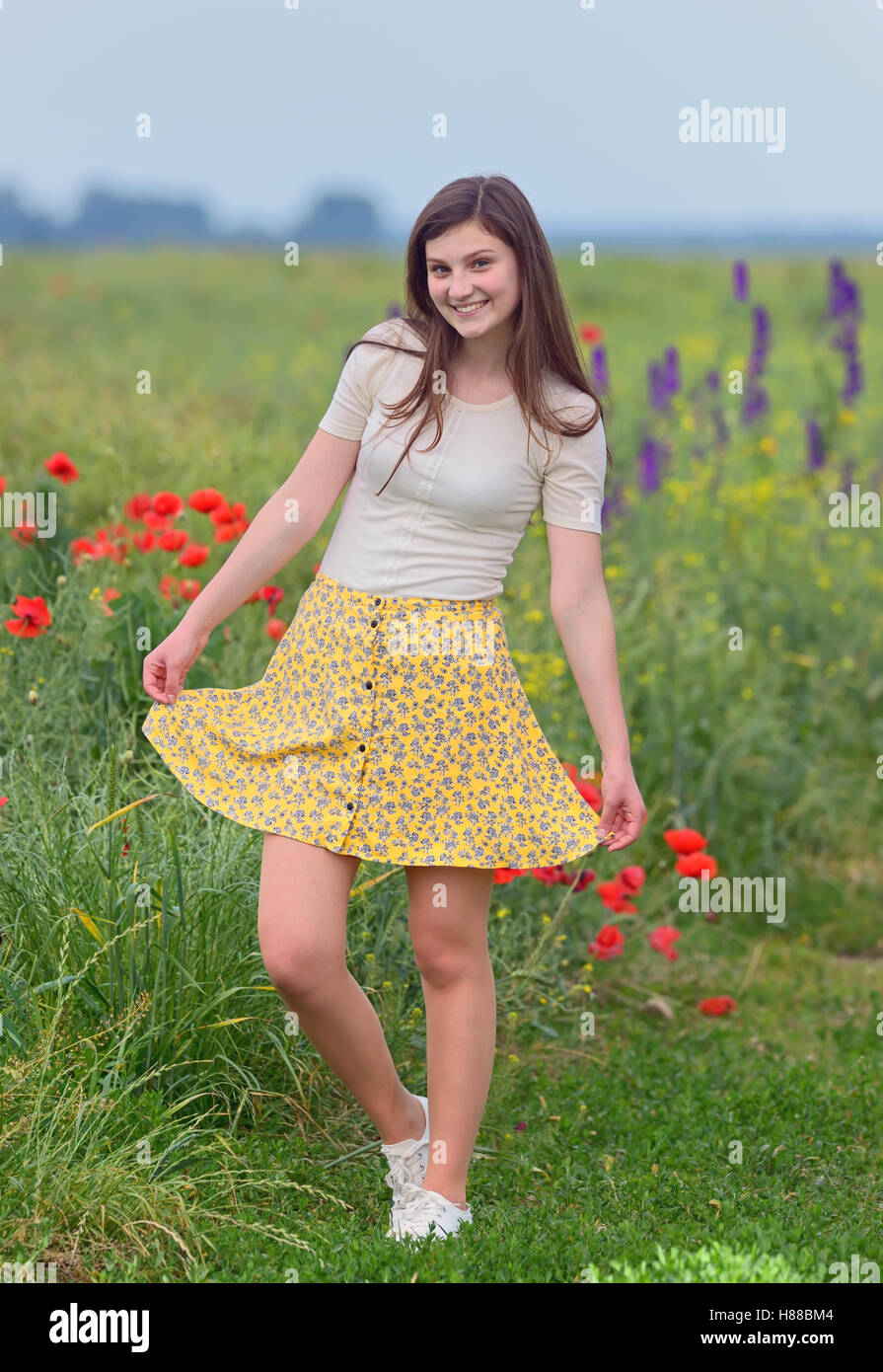 Smiling young girl on summer field Stock Photo