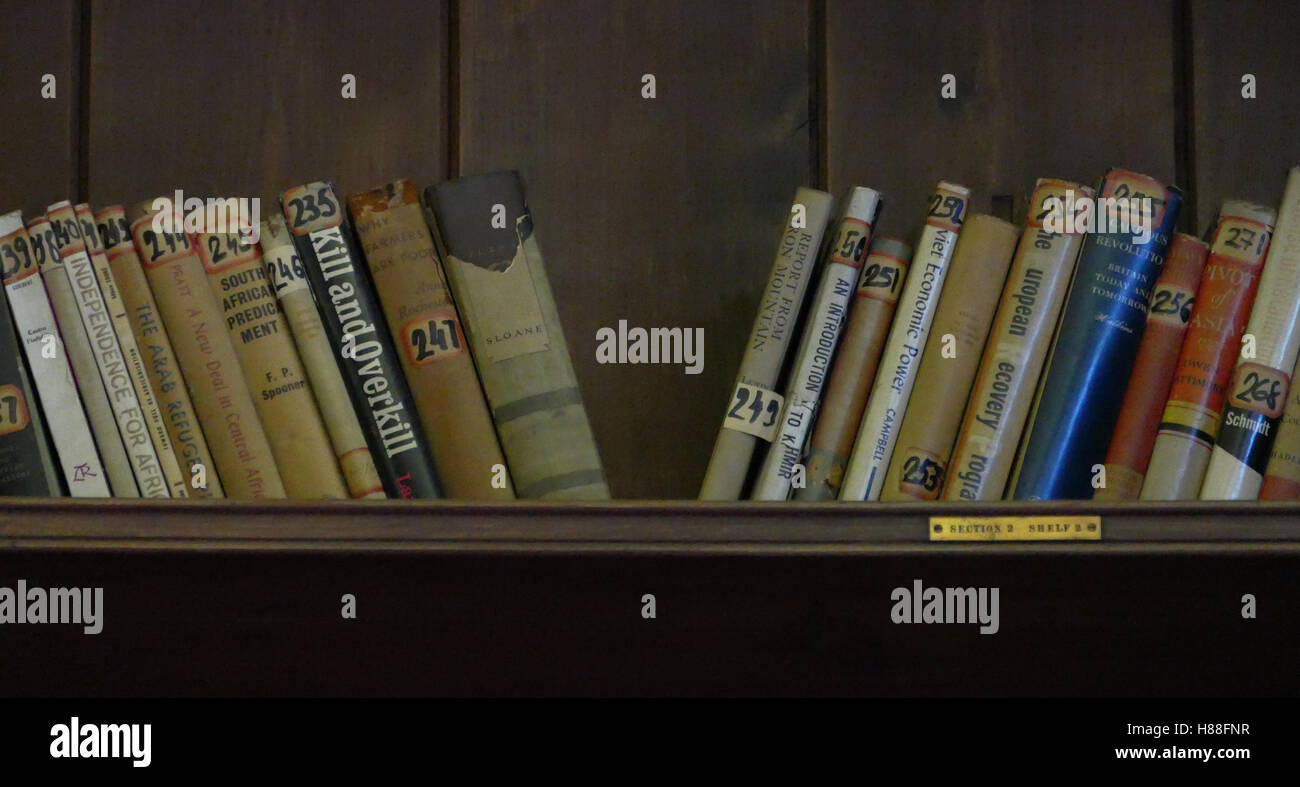 Wooden book shelves with old library books Stock Photo - Alamy