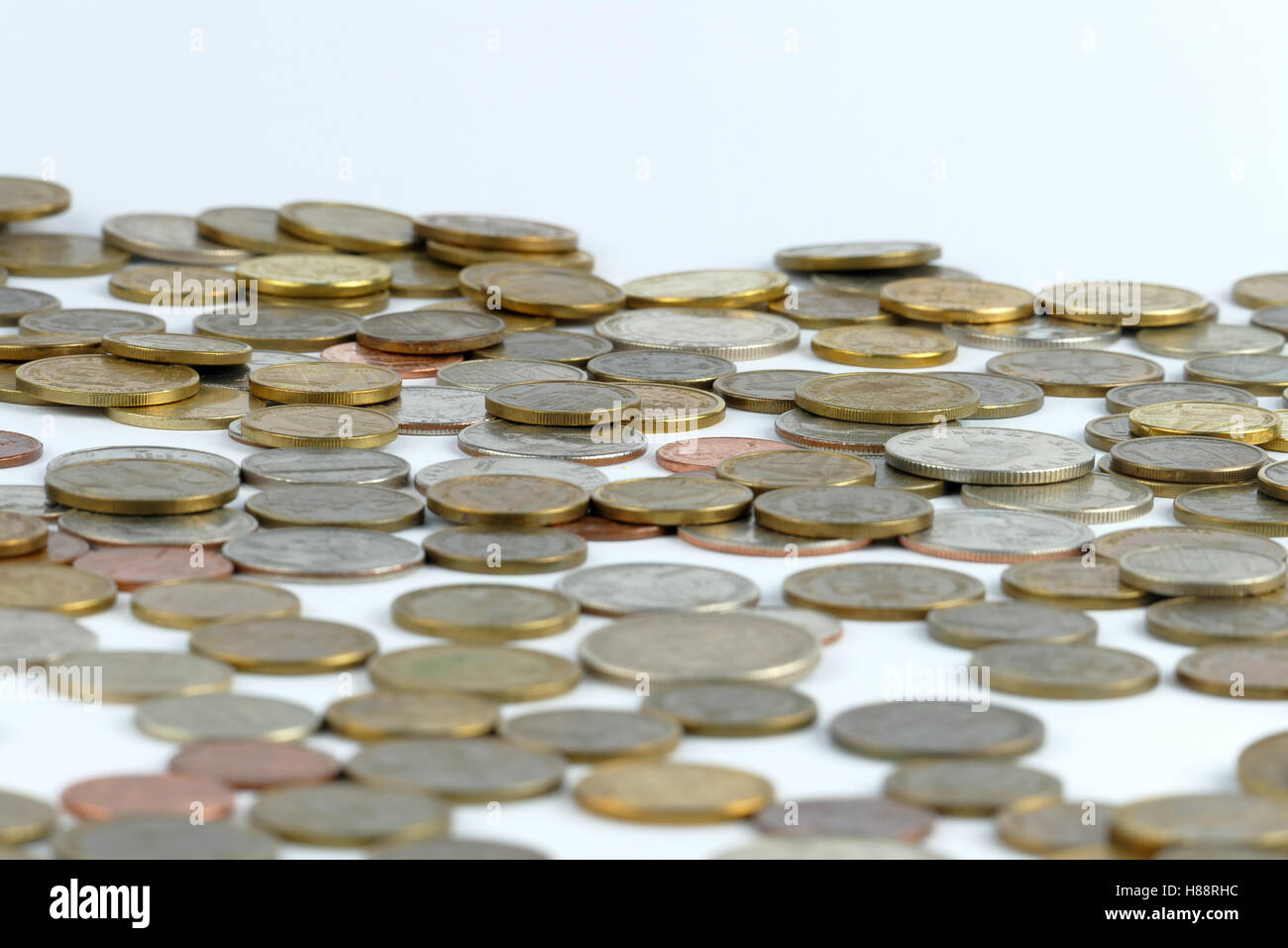 Pile of coin isolated on white background Stock Photo - Alamy
