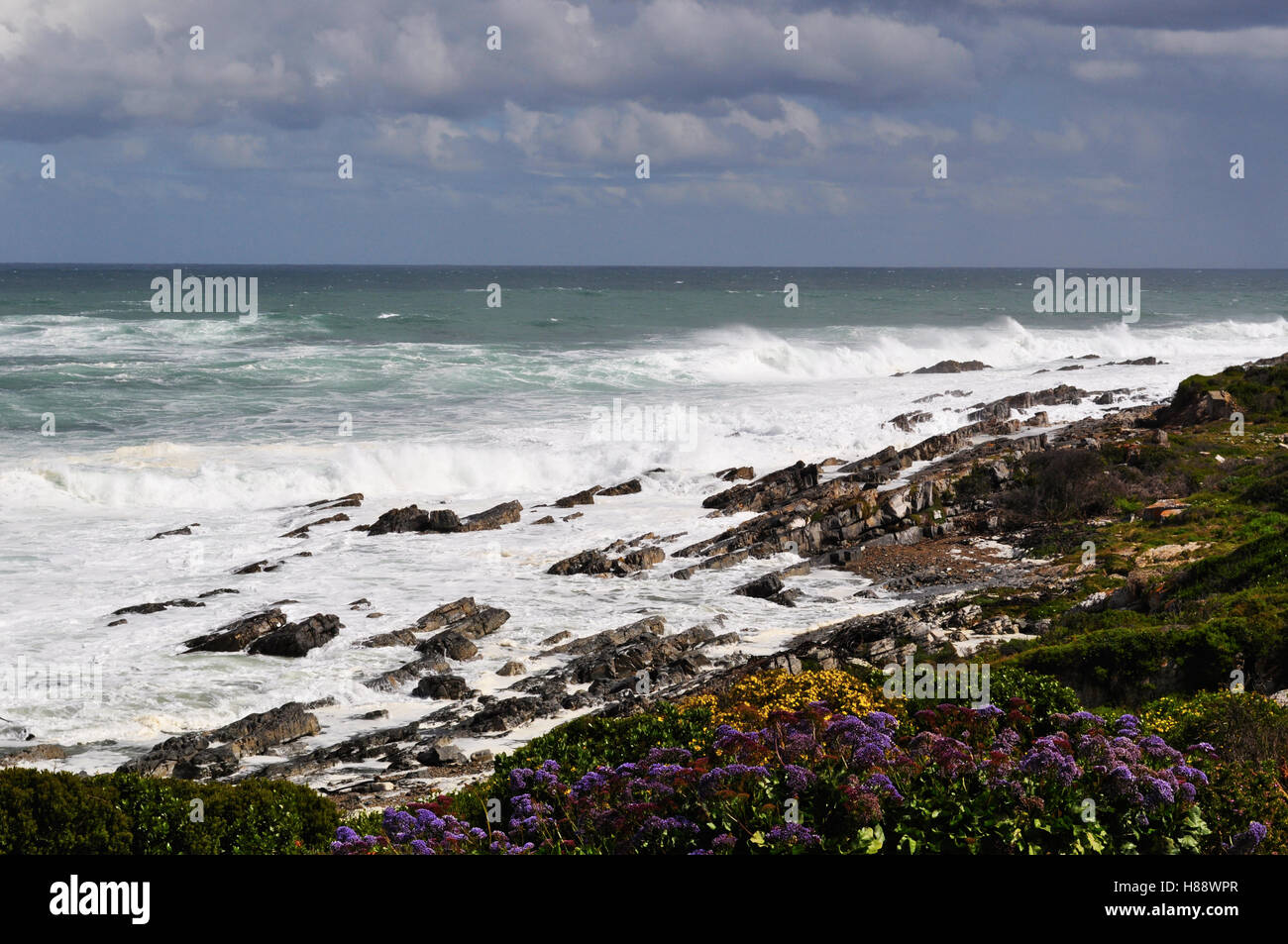 South Africa: stormy Ocean and weather on the rocky beach of Hermanus, a town on the southern coast of the Western Cape Stock Photo