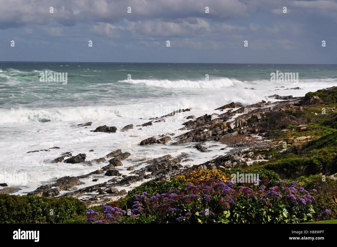 South Africa: stormy Ocean and weather on the rocky beach of Hermanus, a town on the southern coast of the Western Cape Stock Photo