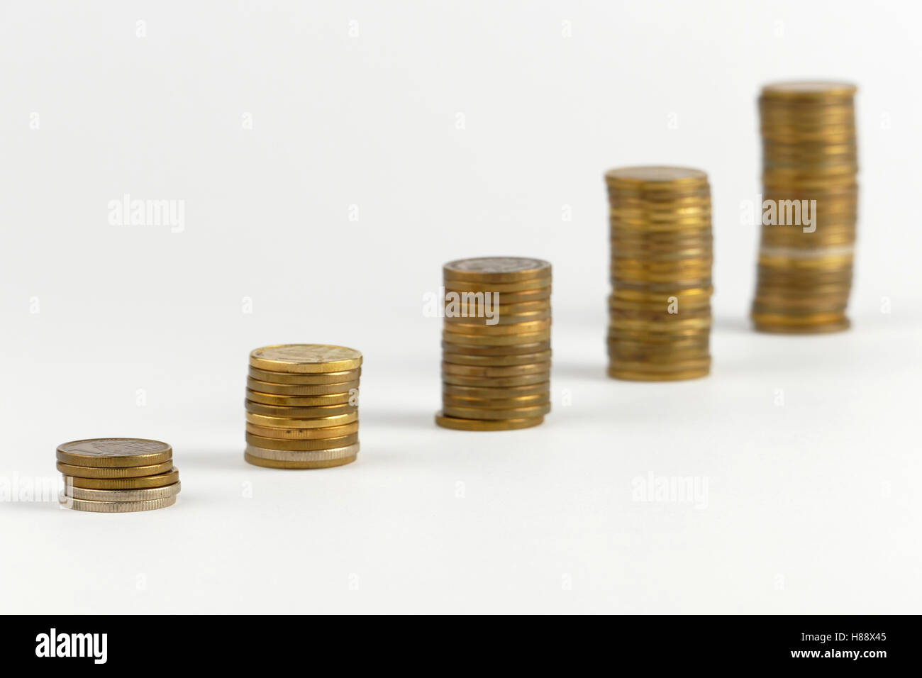 Pile of coins isolated on white background Stock Photo - Alamy