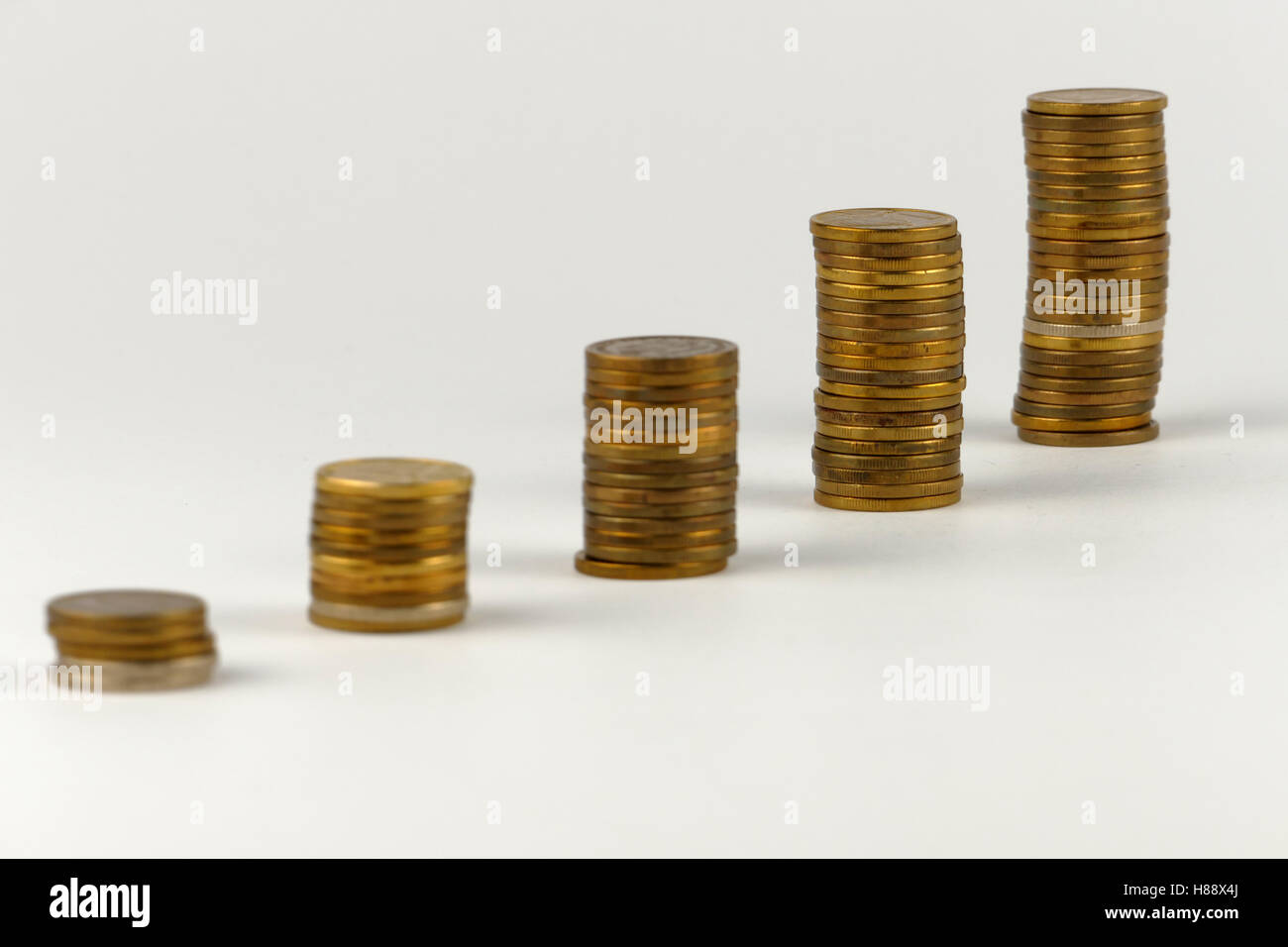 Pile of coins isolated on white background Stock Photo - Alamy