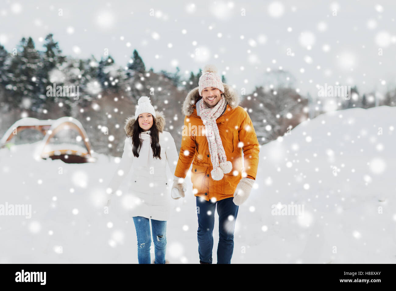 happy couple walking over winter background Stock Photo - Alamy