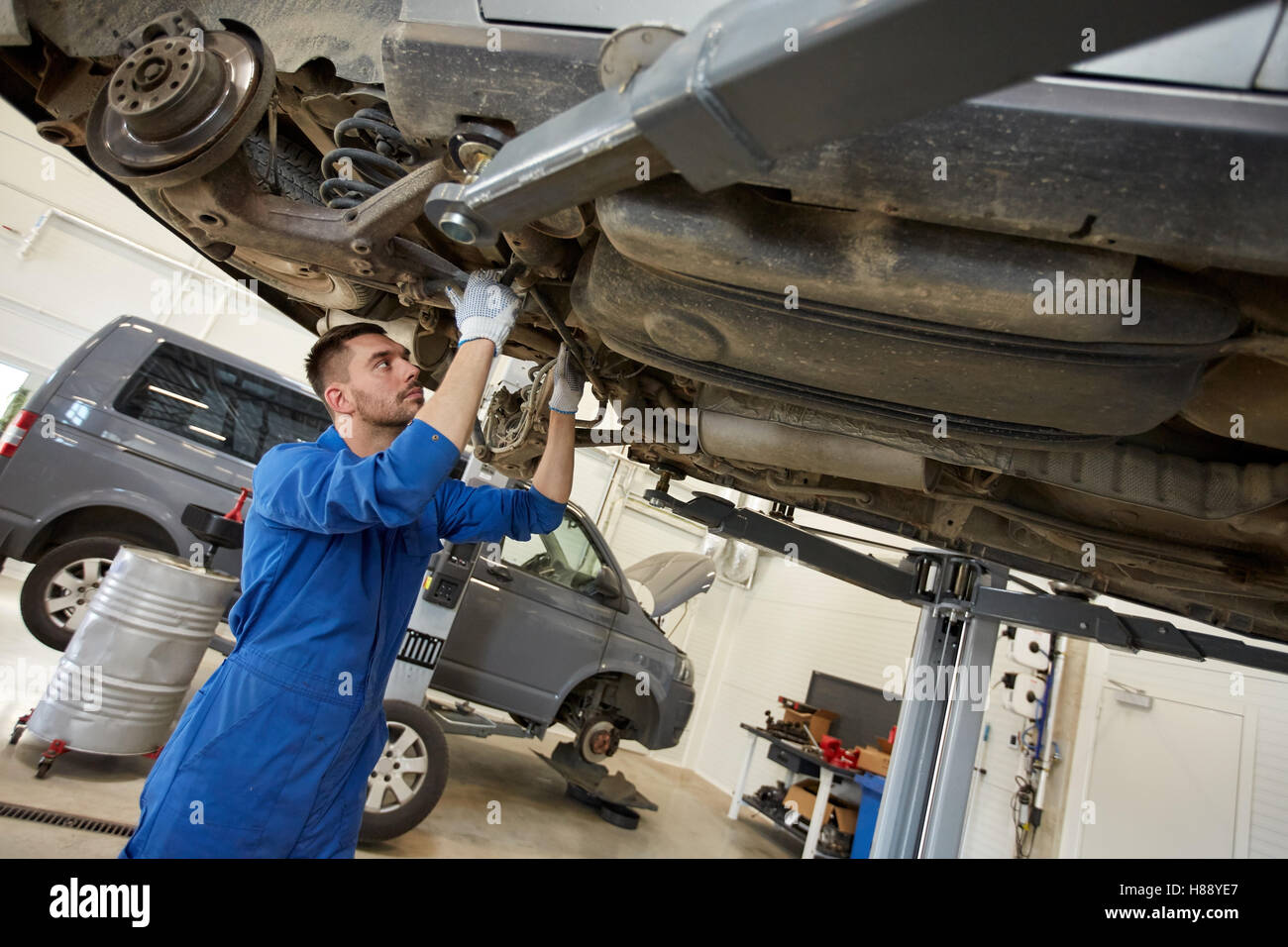 mechanic man or smith repairing car at workshop Stock Photo - Alamy