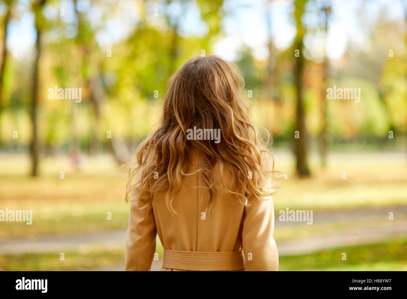 beautiful young woman walking in autumn park Stock Photo - Alamy