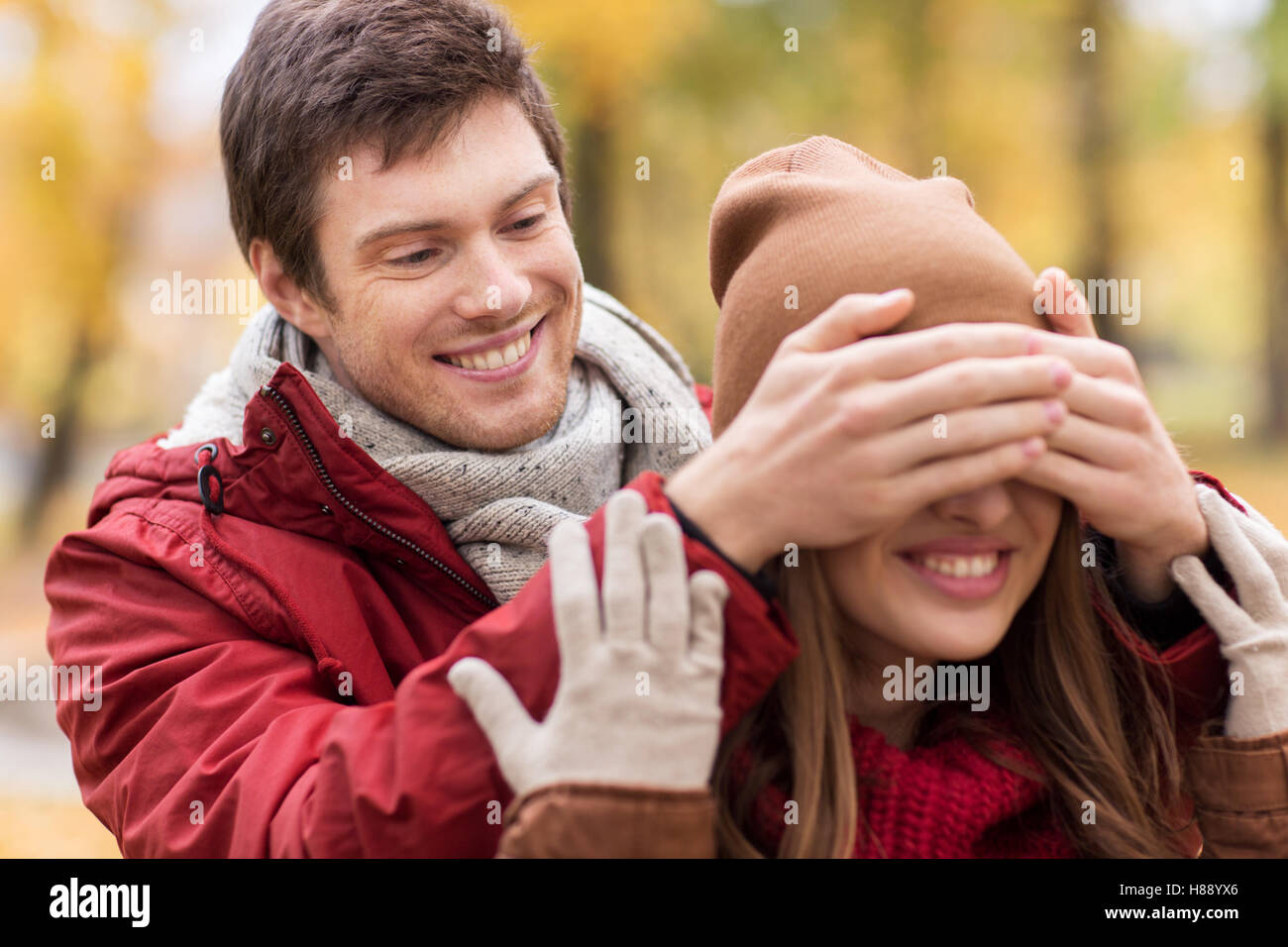 happy young couple having fun in autumn park Stock Photo - Alamy