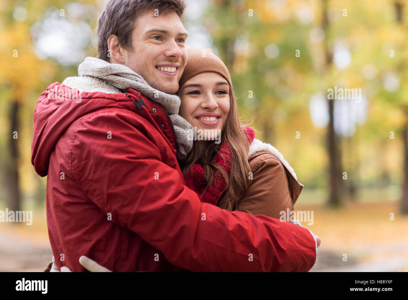 happy young couple hugging in autumn park Stock Photo - Alamy