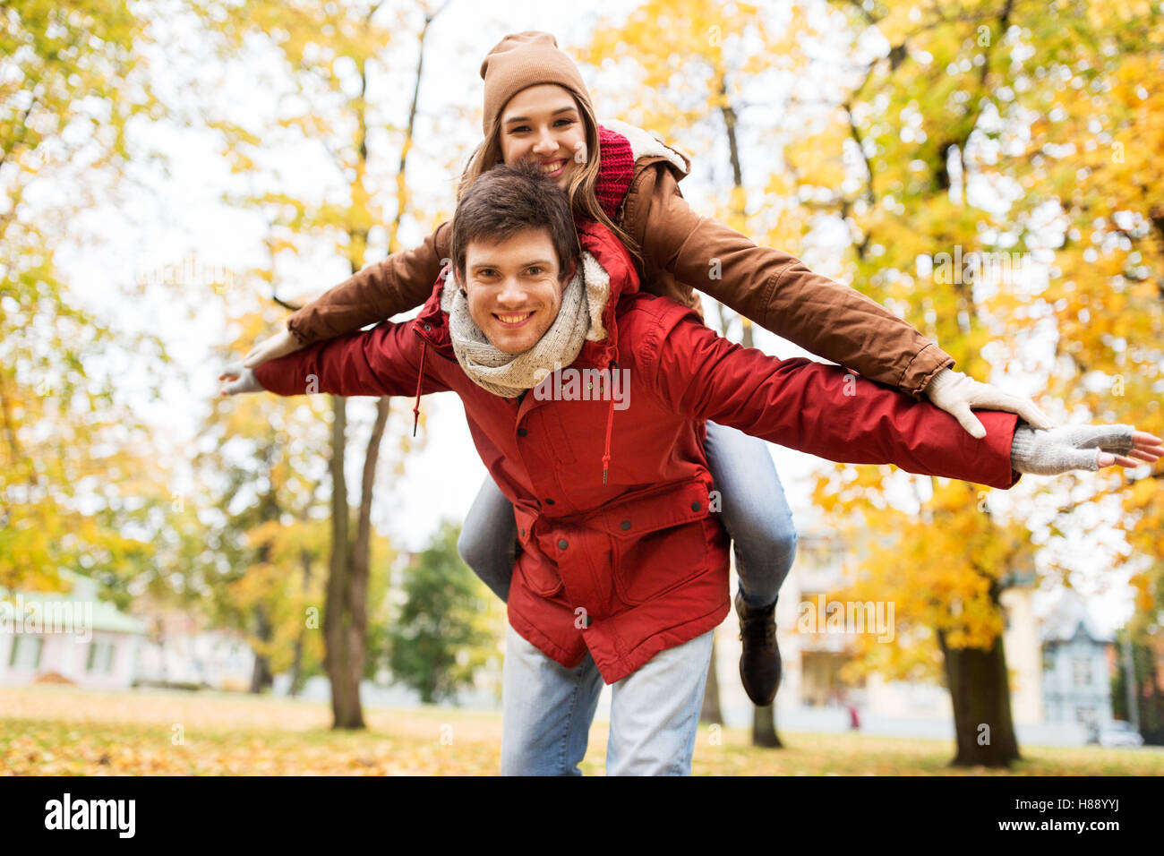 happy young couple having fun in autumn park Stock Photo - Alamy