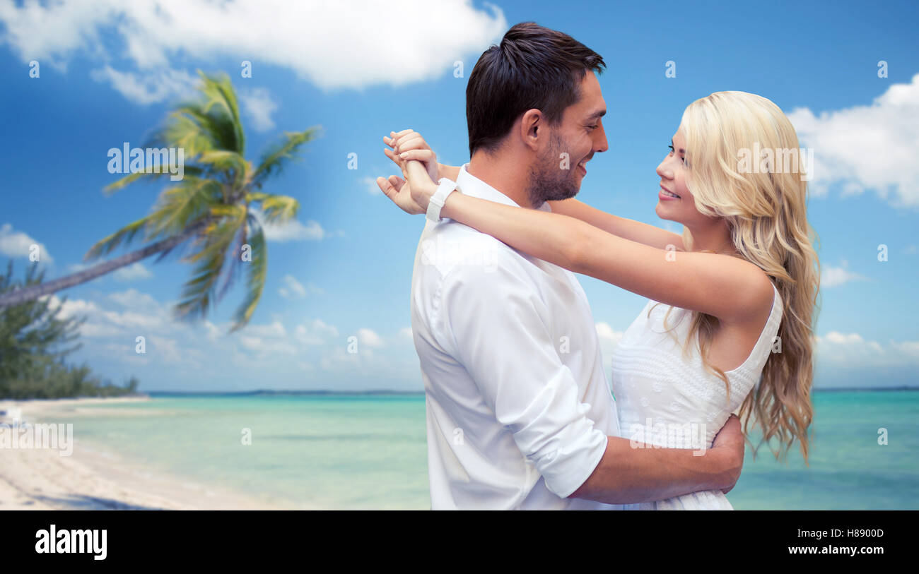 happy couple hugging over beach background Stock Photo - Alamy