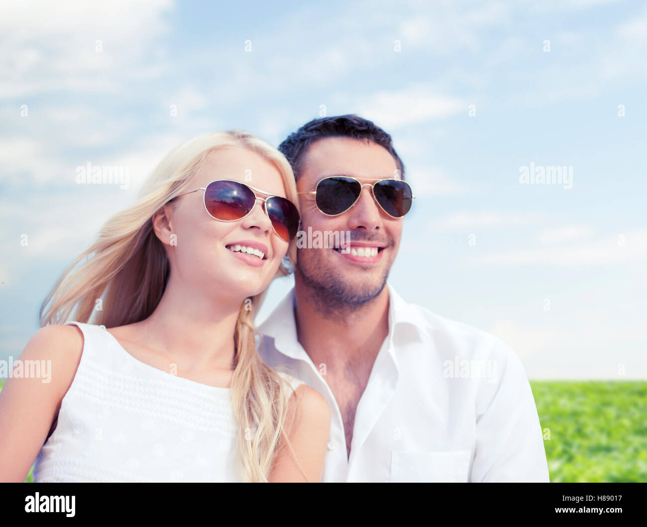 happy couple in shades over natural background Stock Photo - Alamy