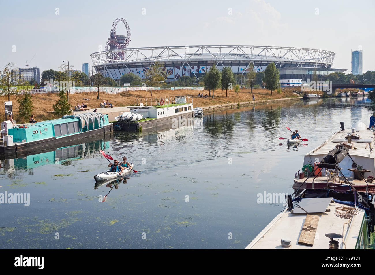 People kayaking on the River Lea in Stratford with London Stadium in the background, London England United Kingdom UK Stock Photo