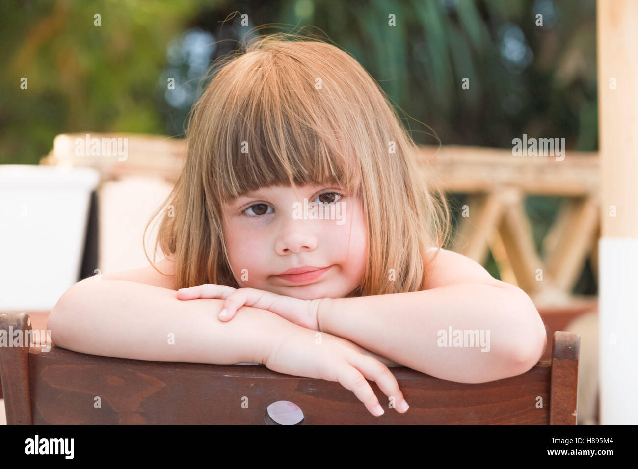 Cute tired Caucasian little girl, close-up outdoor portrait Stock Photo