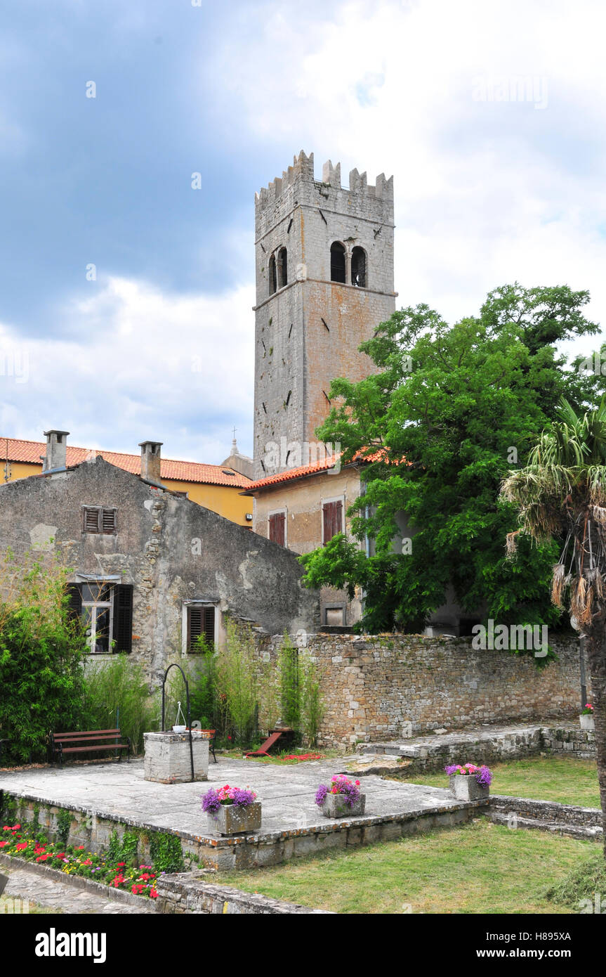 Medieval istrian town of Motovun, Croatia, shot from the castles garden, showing the tower, a well and ancient houses. Stock Photo
