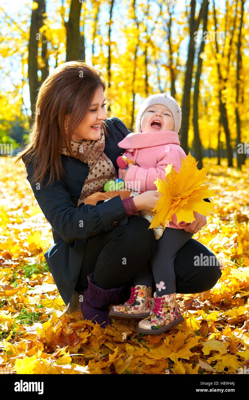 Woman with child girl in autumun city park, happy family Stock Photo ...