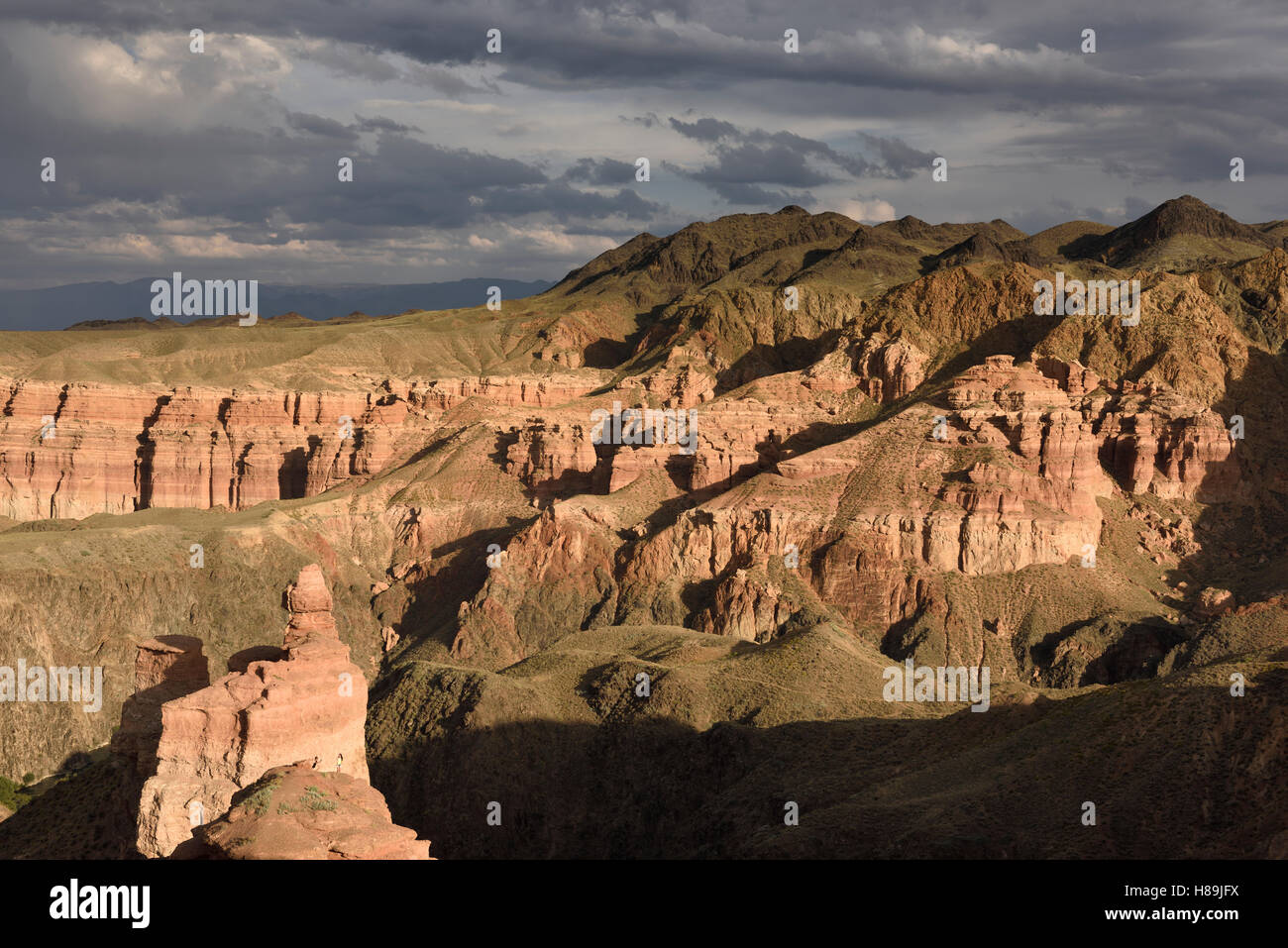 Couple taking picture at sunset on top of Hoodoo at Charyn Canyon Kazakhstan Stock Photo