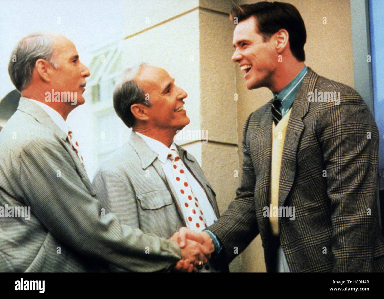 Die Truman Show, (THE TRUMAN SHOW) USA 1998, Regie: Peter Weir, JIM CARREY (re), Stichwort: Händeschütteln Stock Photo
