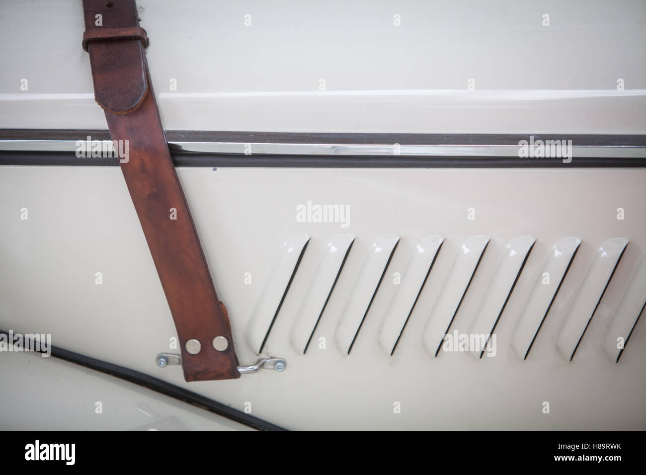 Close up shot of a leather belt on a vintage car's hood Stock Photo Alamy