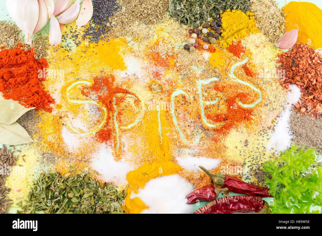 Word spices written in colorful seasoning background. Love cooking Stock Photo