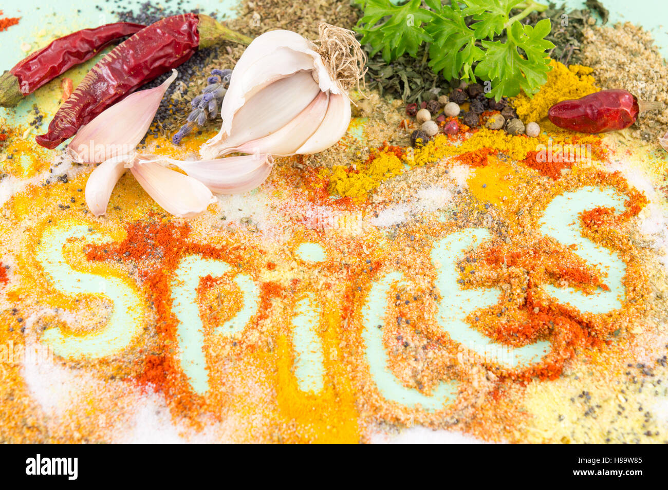Word spices written in colorful seasoning background. Love cooking Stock Photo