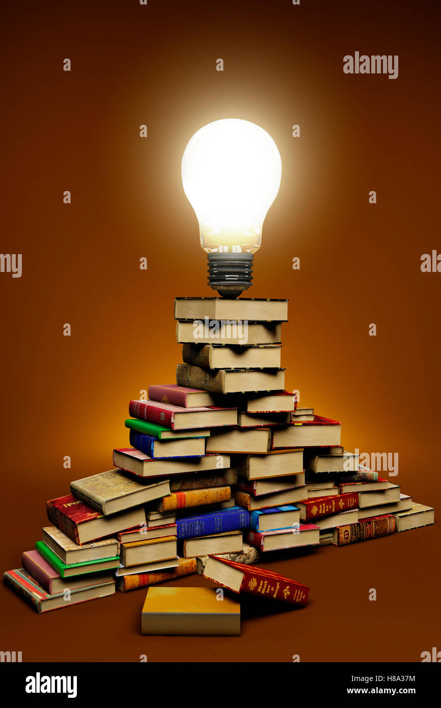 lightbulb on top of a stack of books Stock Photo