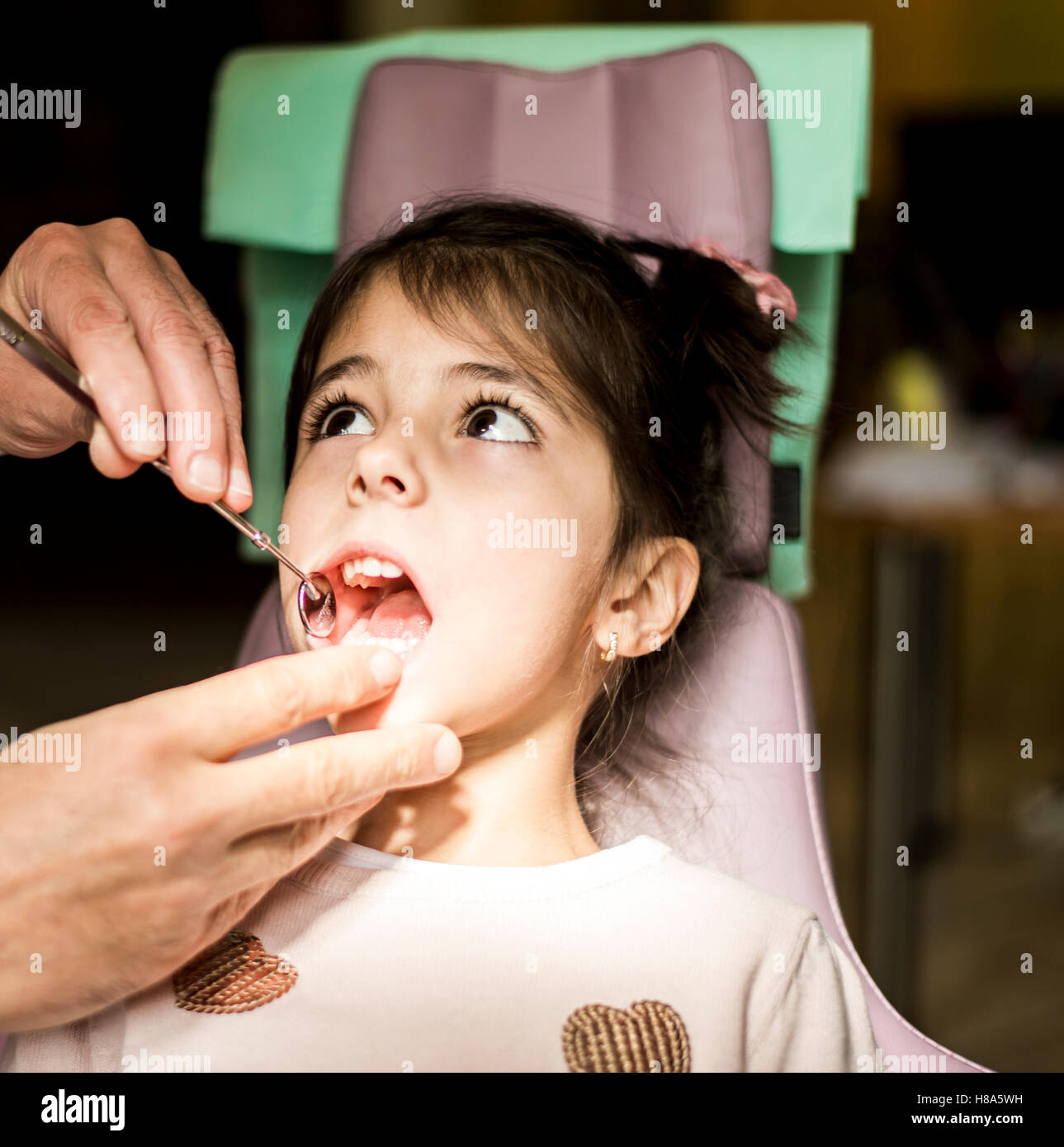 View at little girl at the dentist checkup Stock Photo