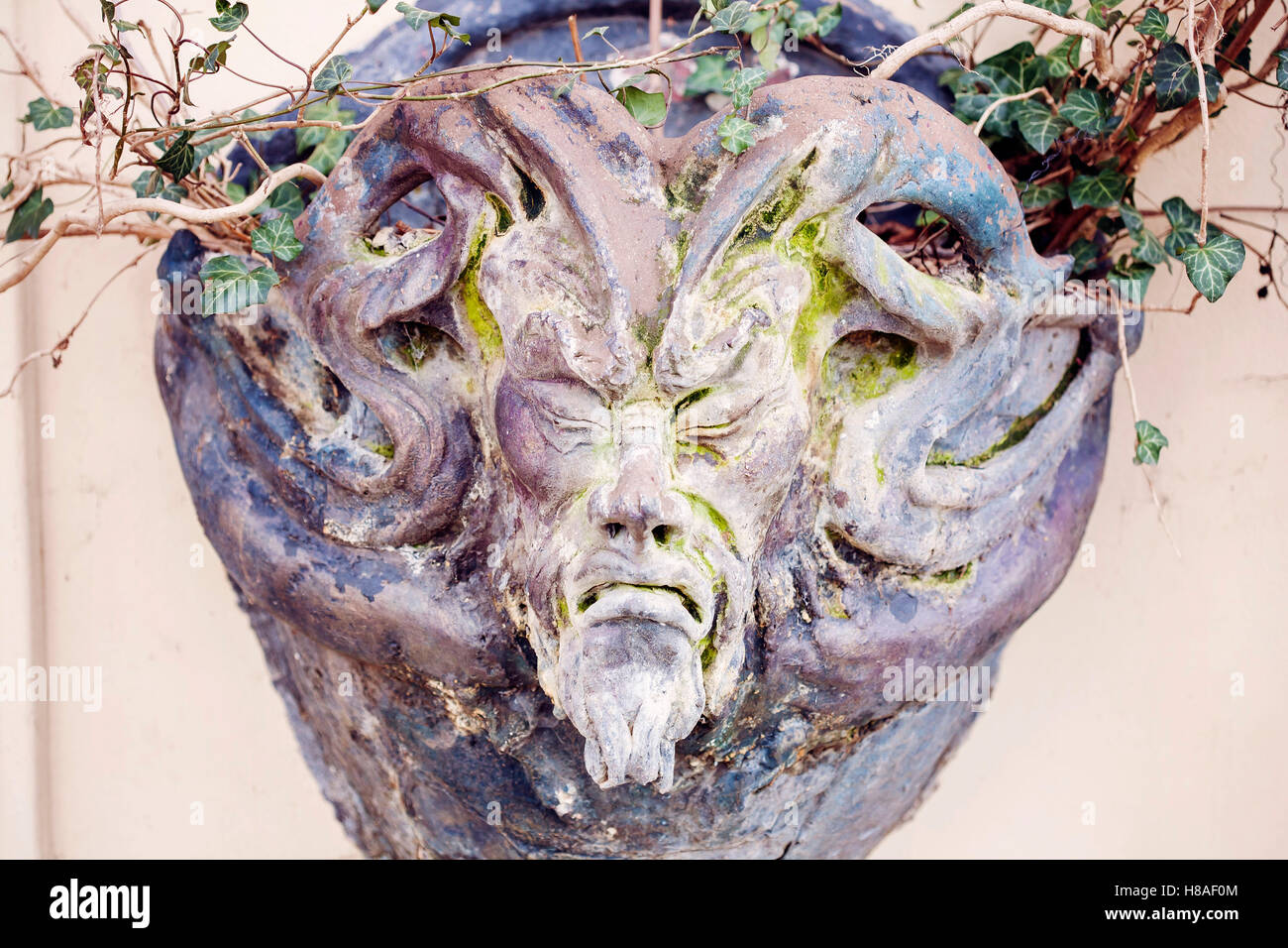 Satyr Woodland god face sculpture Stock Photo