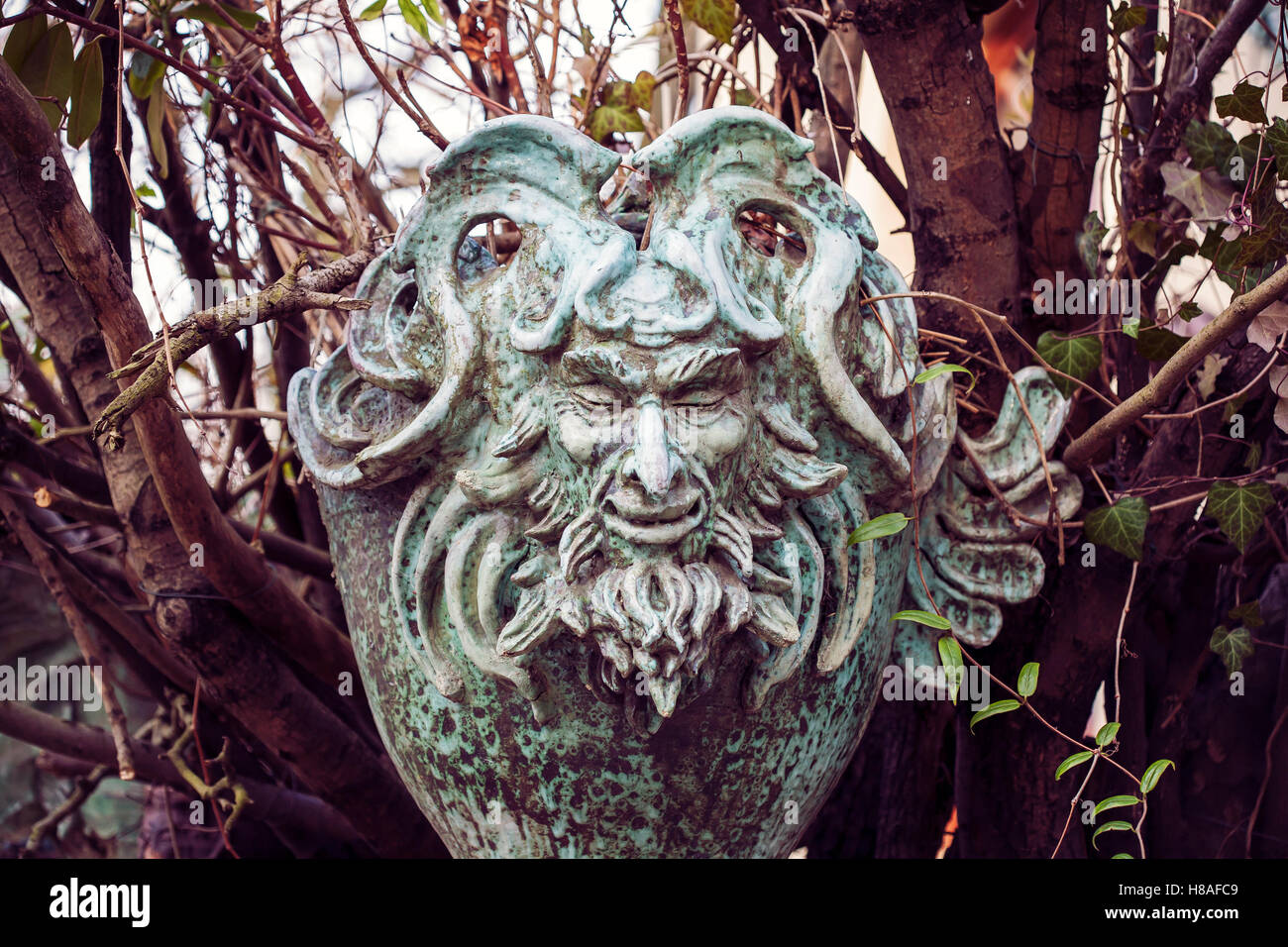 Satyr Woodland god face sculpture Stock Photo
