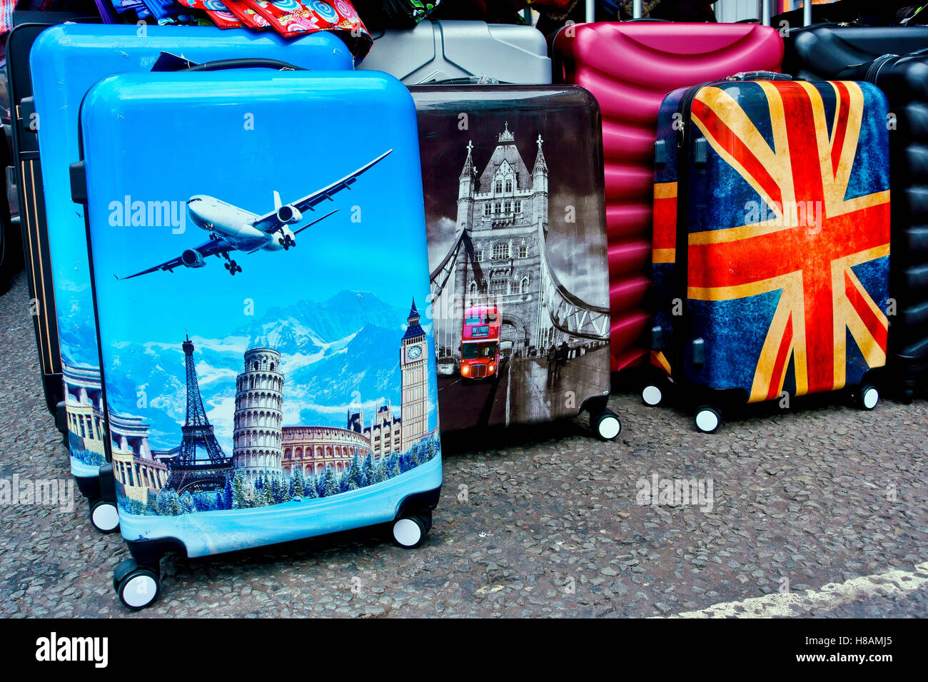 Suitcases with airplane, landmark, tower bridge, Union Jack flag, British flag. On display at Portobello Road Market, London, England, UK. Close up. Stock Photo