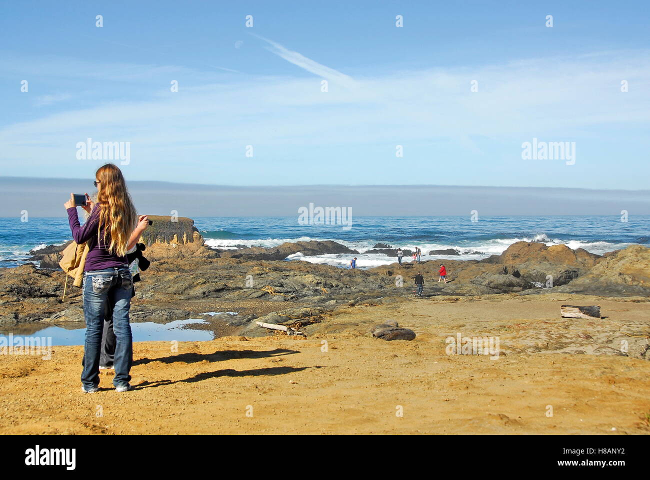 Hikers on bluff above Glass Beach in MacKerricher State Park Fort Bragg