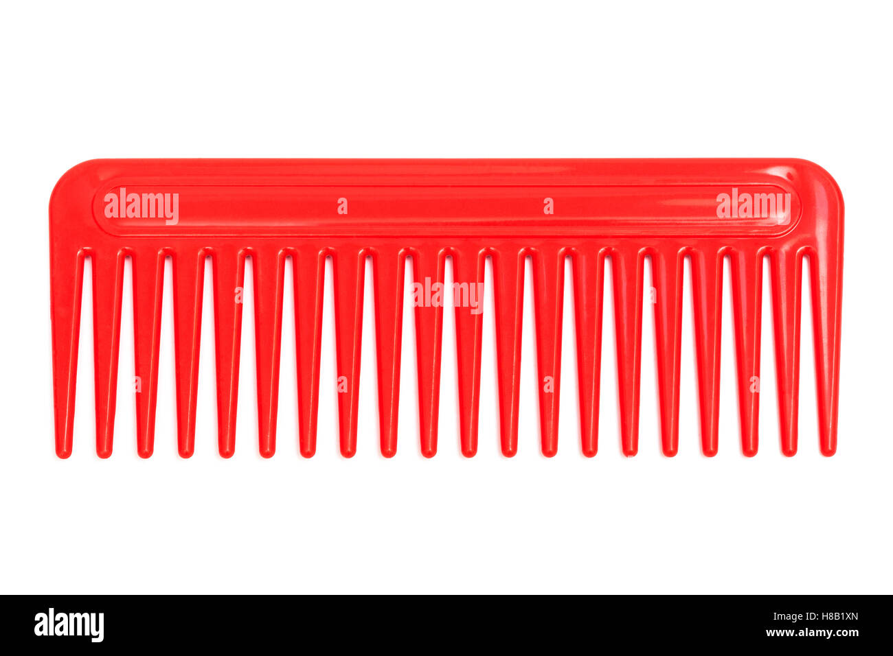 red plastic comb on a white background Stock Photo Alamy
