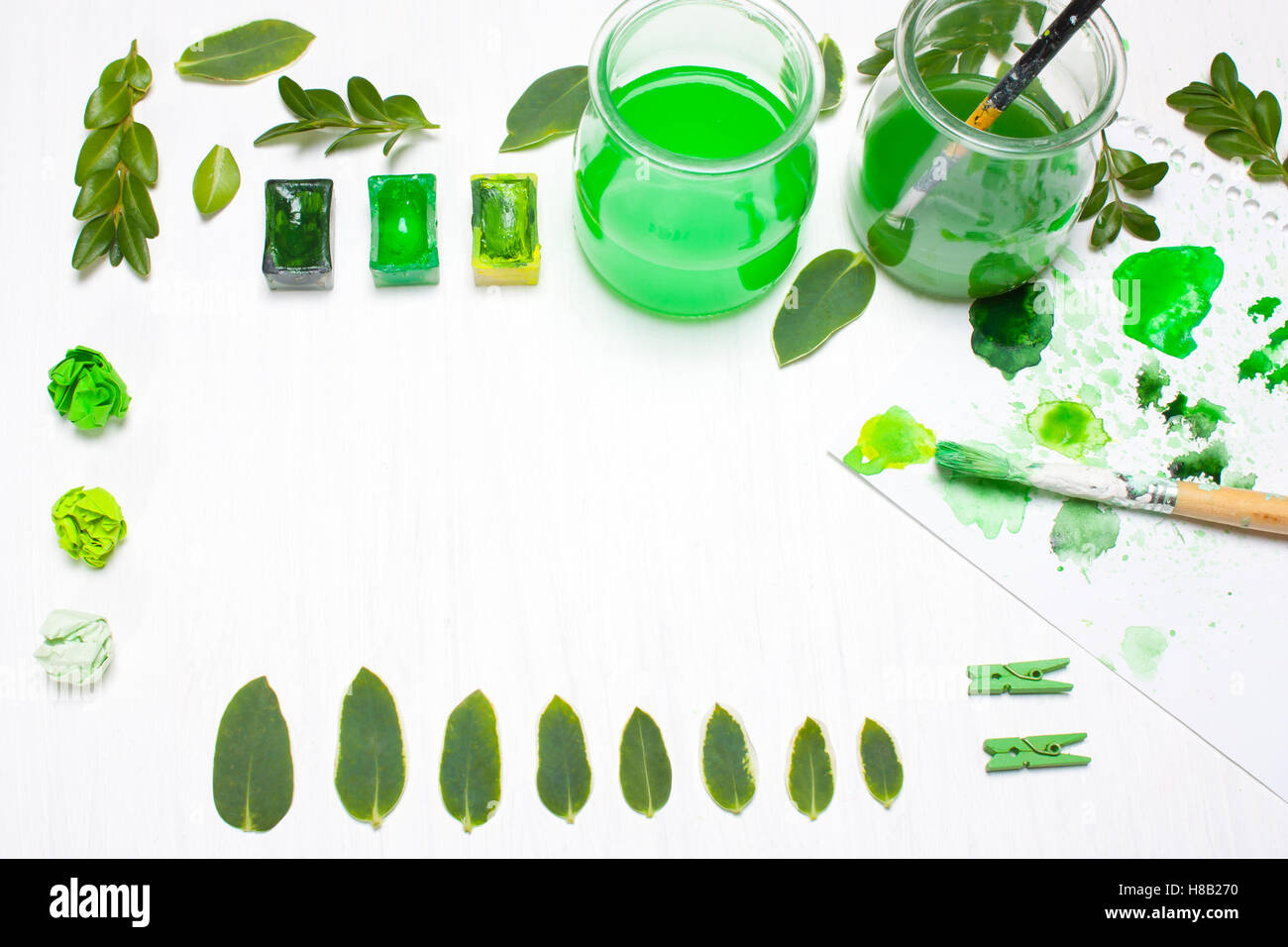 Green leaves draws the artist. Concept art. creative concept, creativity.Workplace, designer table.Flat lay, overhead view Stock Photo