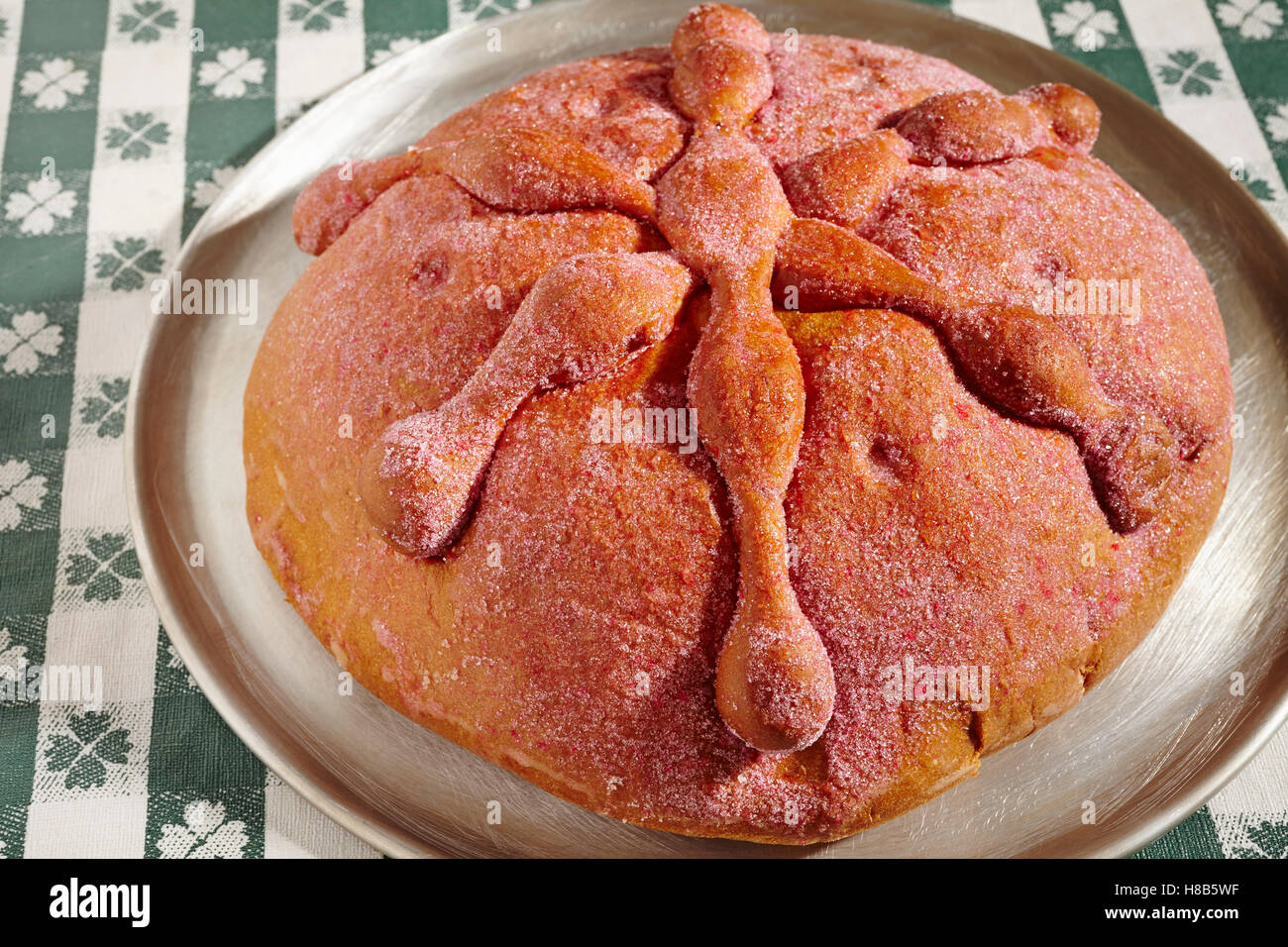loaf of Mexican red sweet bread with bone decorations for The Day of the Dead Stock Photo