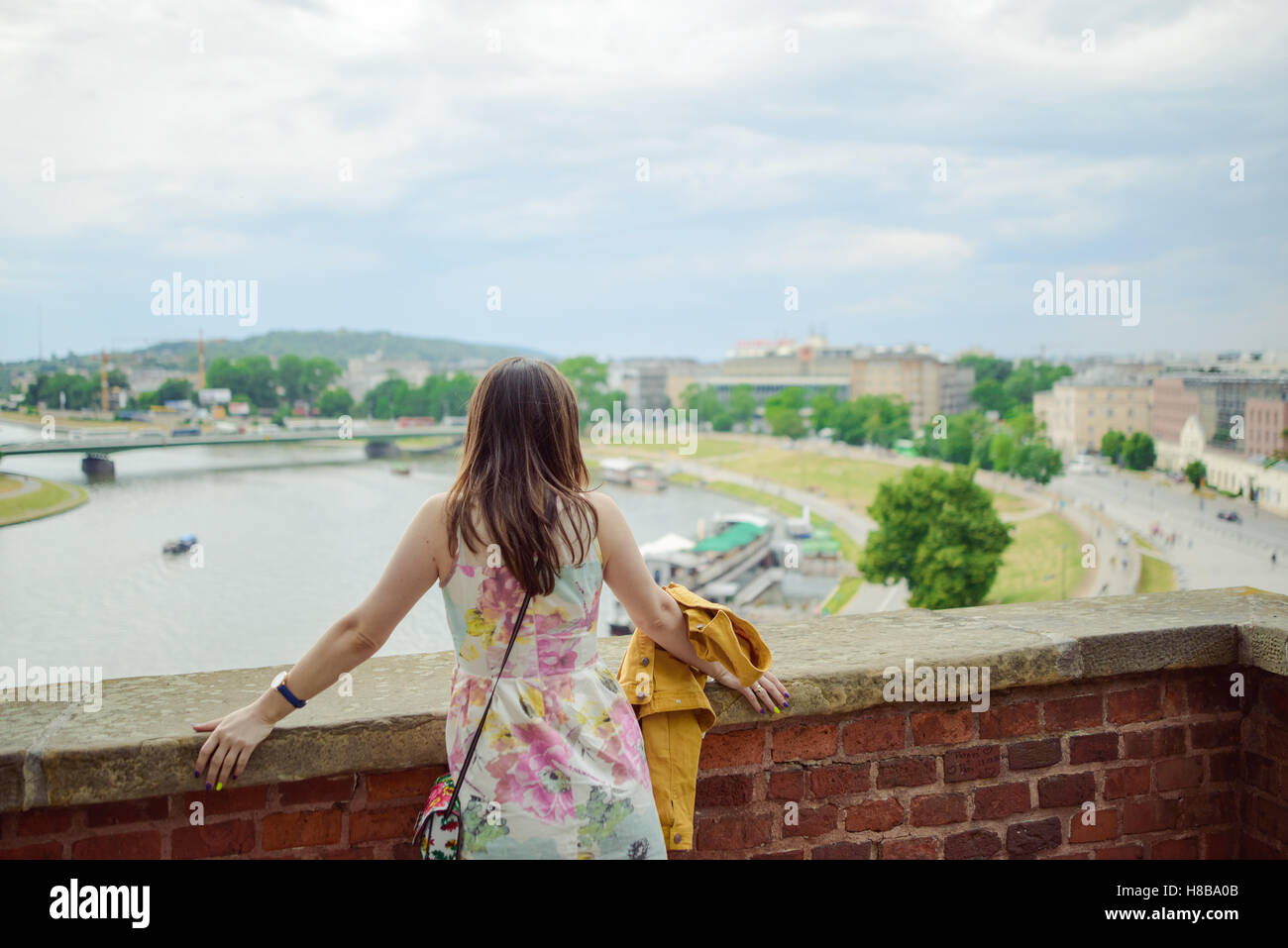 A stylish girl looking at the river Stock Photo - Alamy