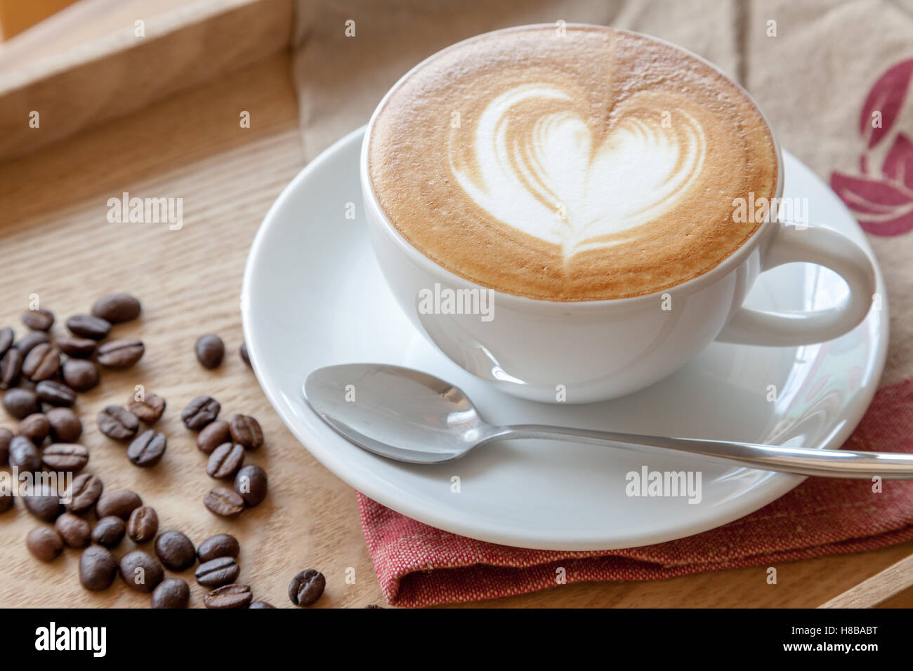 Coffee cup of Cafe' latte with heart latte art on top Stock Photo