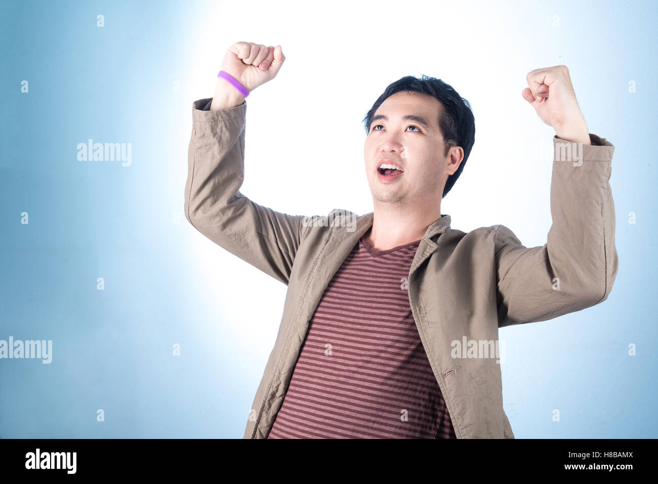 Successful happy and attractive businessman rejoicing raising his face