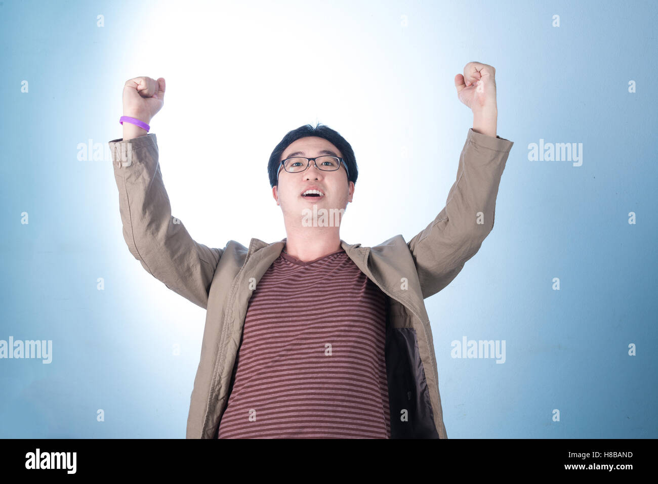 Successful happy and attractive businessman rejoicing raising his face