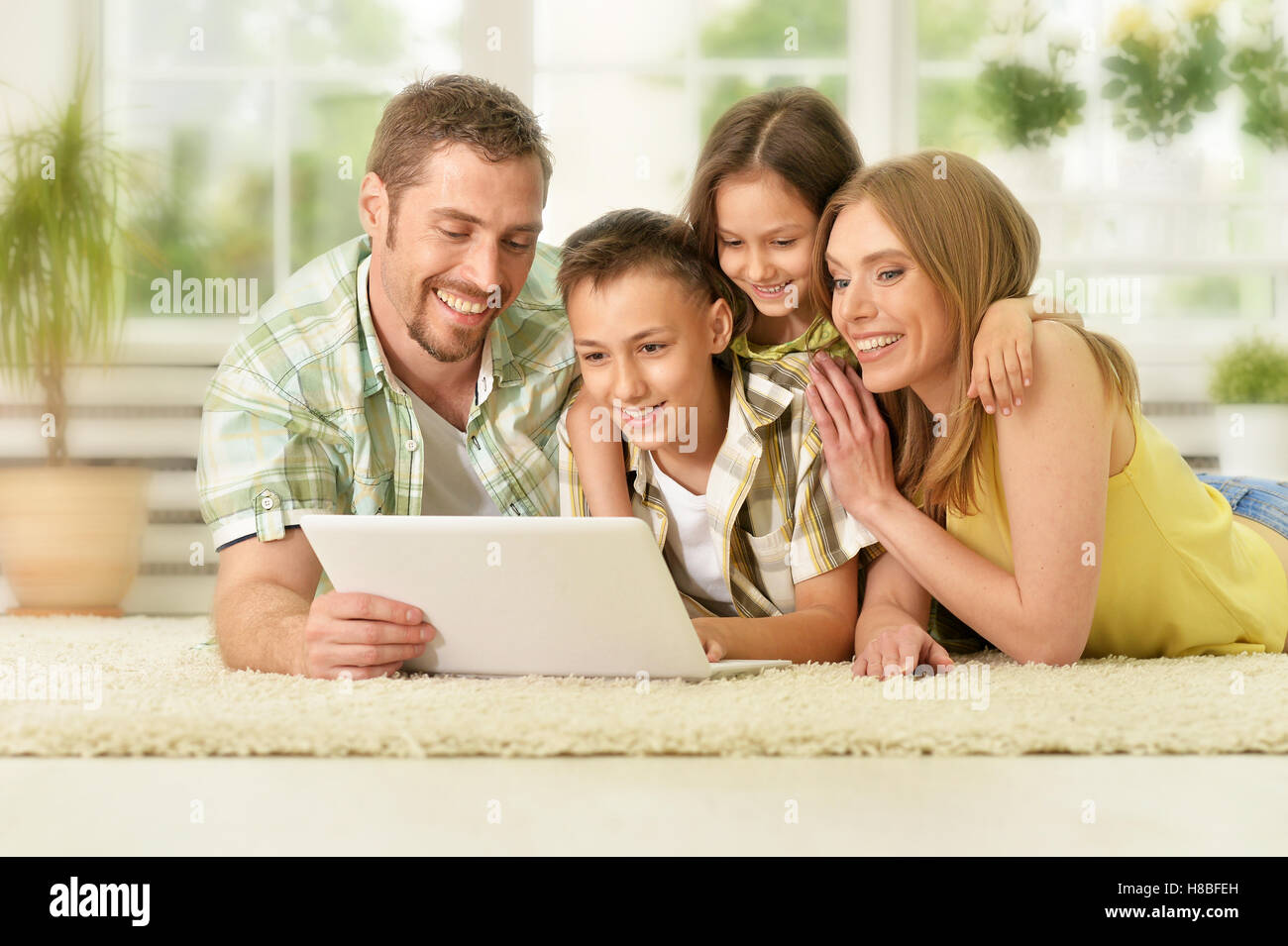 family at home with laptop Stock Photo - Alamy