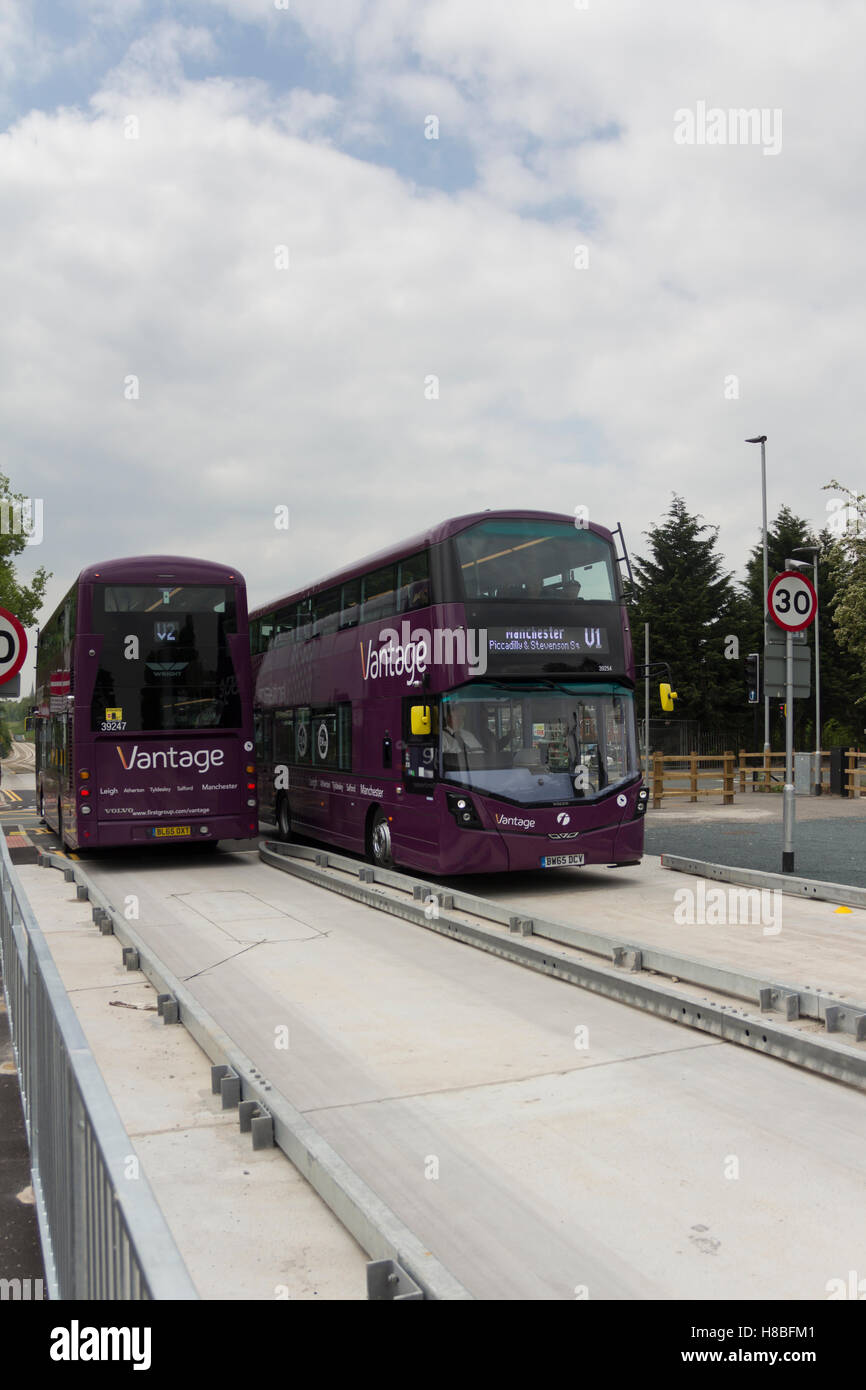 Vantage branded buses pass each other at the Manchester to Leigh guided busway stop at Hough Lane, Tyldsely. Stock Photo