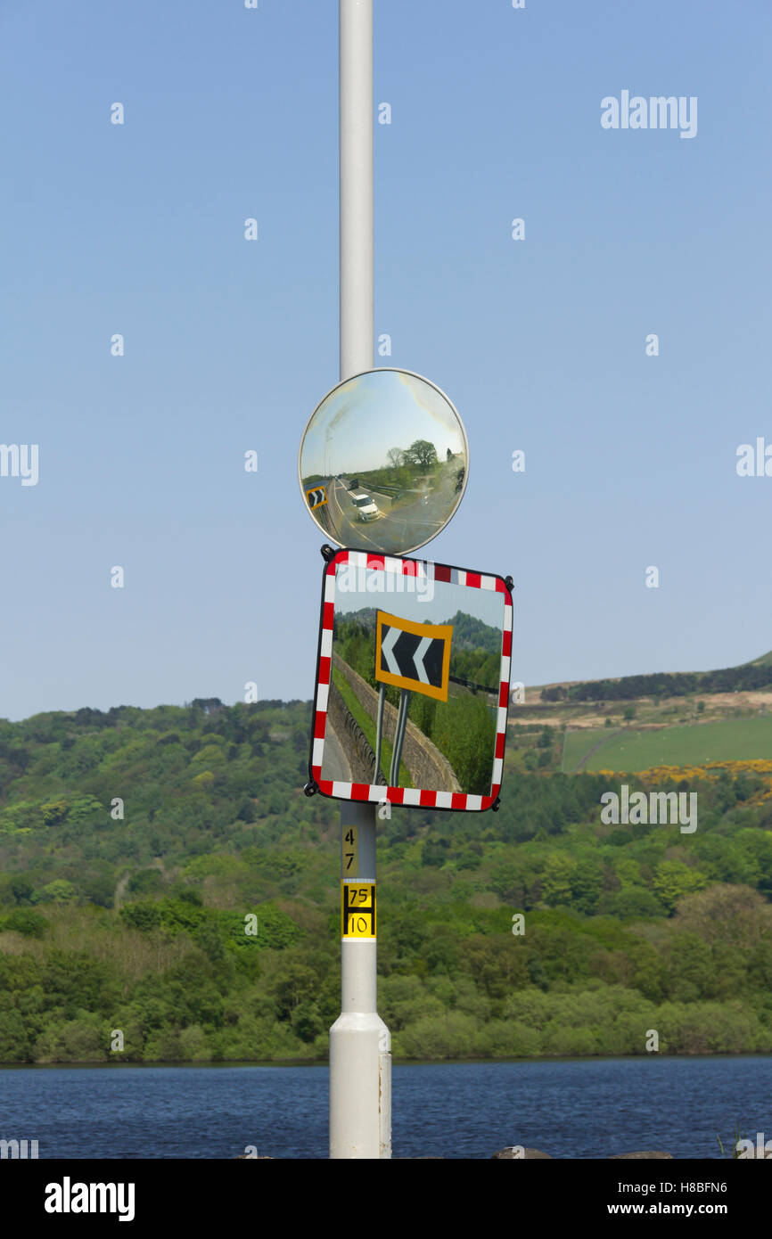 Two saftey mirrors to help drivers emerging from a concealed entrance on the inside of a bend in the road. The A673 has a severe Stock Photo