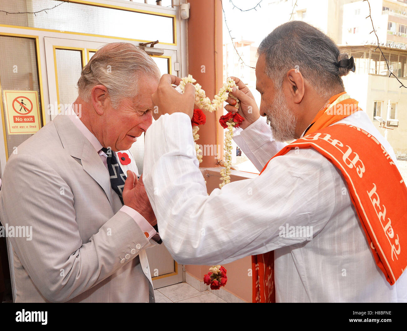 The Prince of Wales receives a garland of flowers on arrival at the Krishna Temple, in Manama