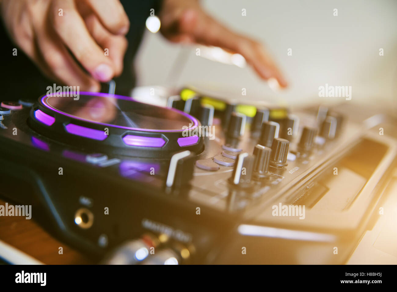 DJ turntable console mixer controlling Stock Photo - Alamy