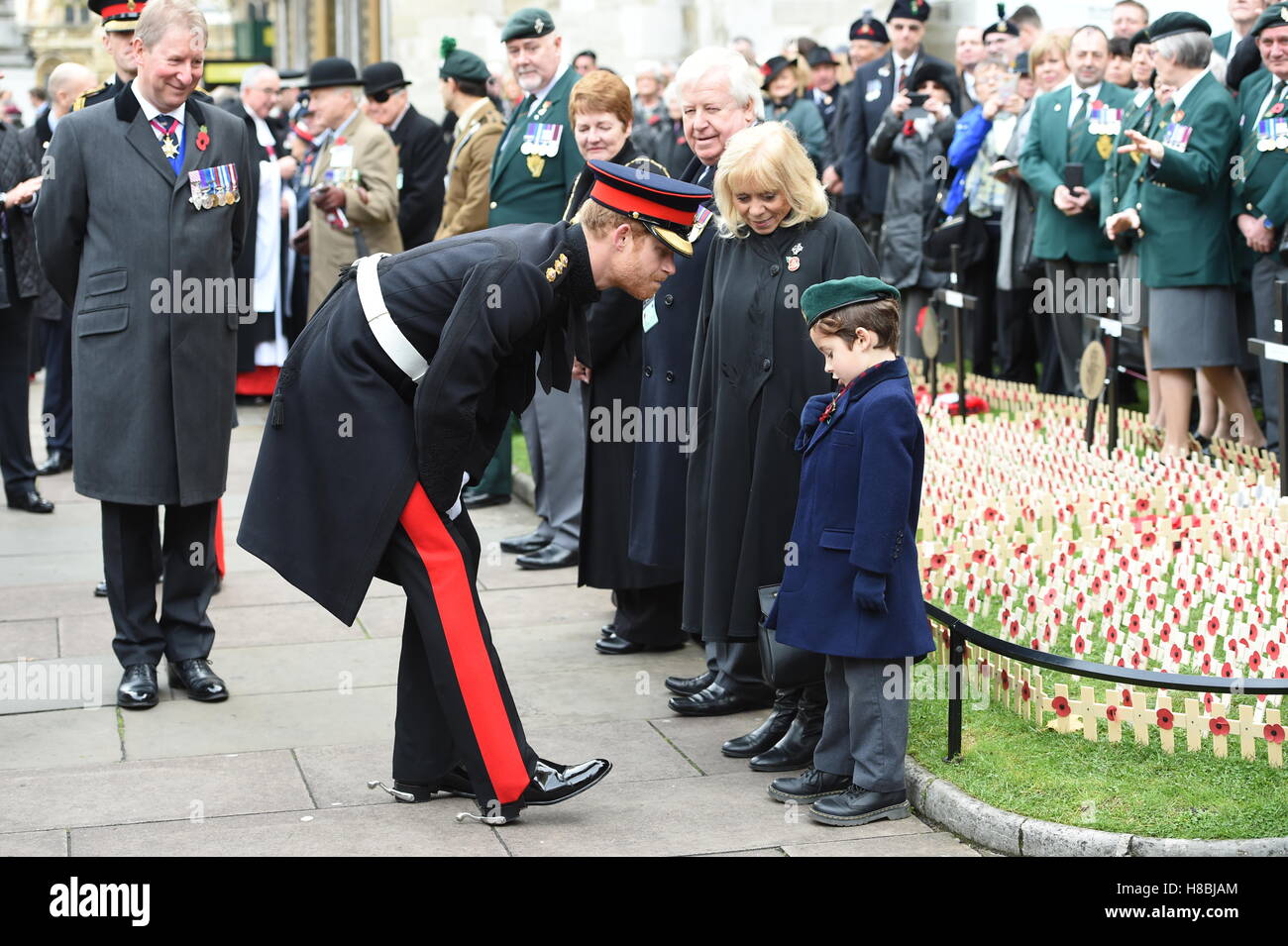 Prince Harry greets a child at London's Westminster Abbey where he and the Duke of Edinburgh visited the Field of Remembrance, observed a two minutes' silence and met veterans from past and more recent conflicts. Stock Photo