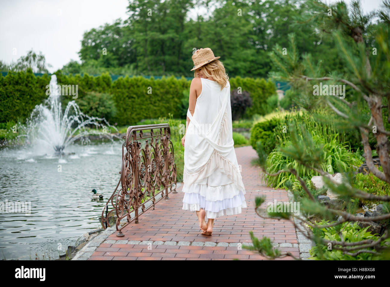 Woman walking barefoot park hi-res stock photography and images - Alamy