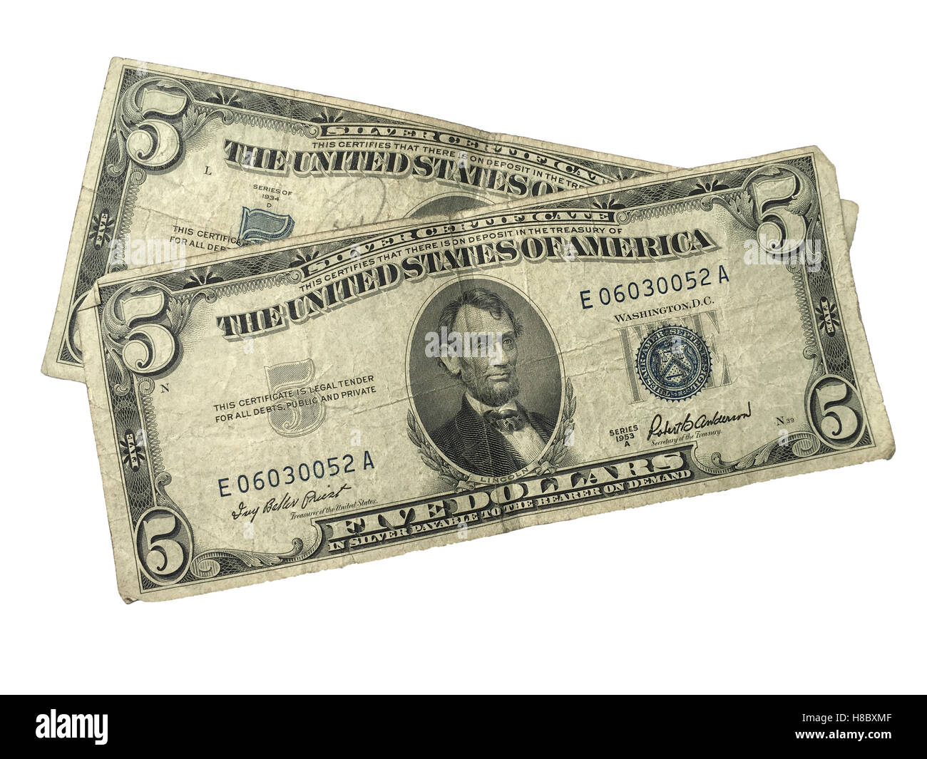 Two old 5 dollar silver certificates in used condition on white background. Stock Photo