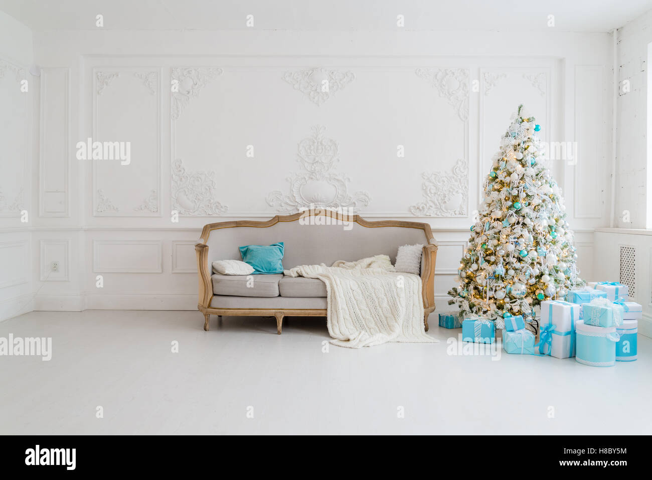 Stylish Christmas interior with an elegant sofa. Comfort home. Presents ...