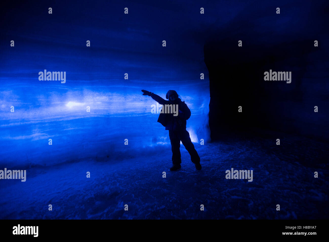 A young girl poses in an ice cave during the Into the Glacier tour at Langjökull Glacier outside Húsafell, western Iceland Stock Photo