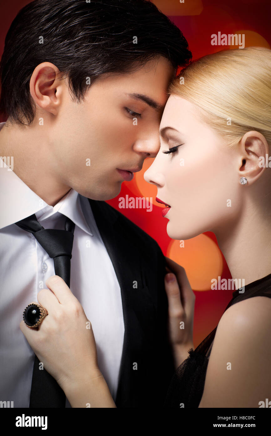 Elegant young couple cuddling at party Stock Photo