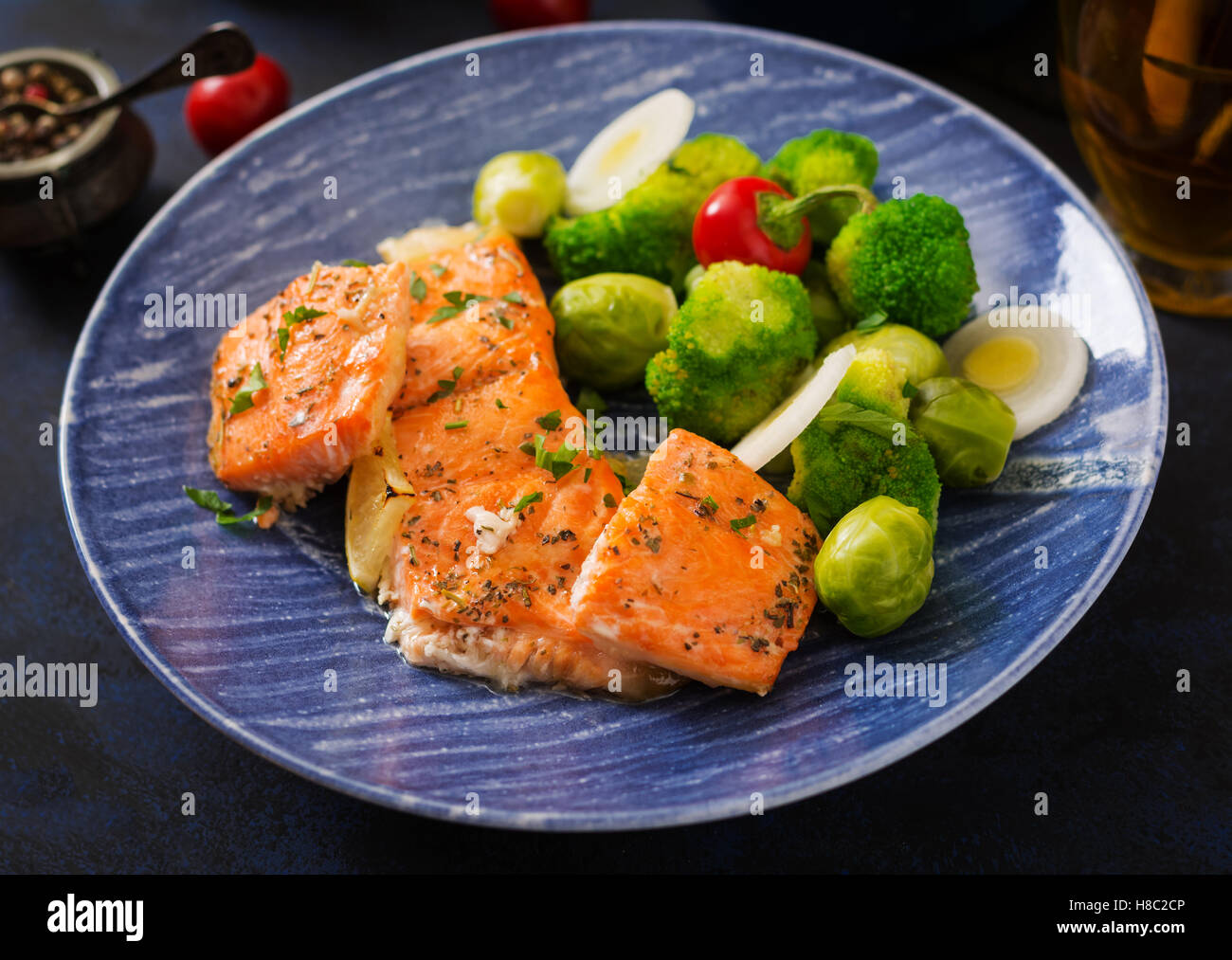 Baked salmon fish garnished with broccoli and Brussels sprouts with ...